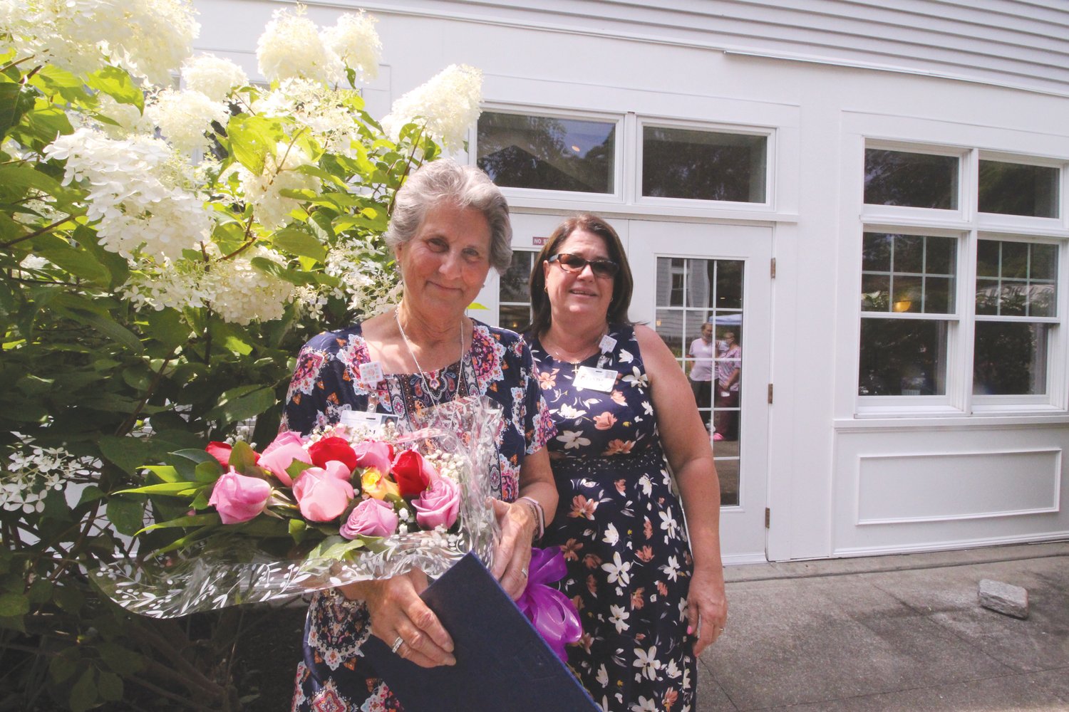 A ROSE FOR EVERY YEAR: Linda Sinnott, program director, presented Kim Morris with a bouquet of roses – one rose for every year – Monday at Cornerstone Adult Day Care Services, where Morris has worked for the past 35 years.